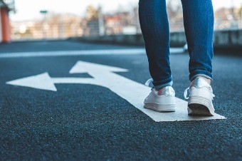 make-decision-which-way-to-go-walking-on-directional-sign-on-asphalt-picture-id1138420319.jpg